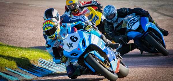 Motorcycles racing around a track.