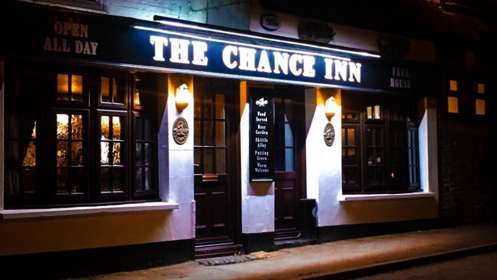 A night time photo of the entrance to The Chance Inn