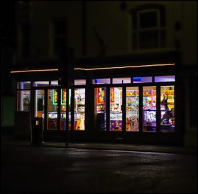 A street scene at night and the bright colourful lights of an amusement arcade