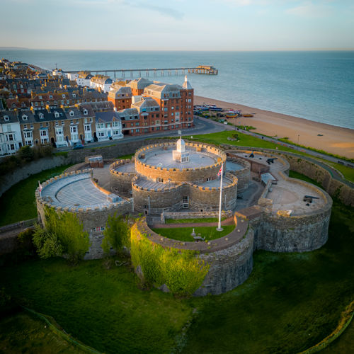 An aerial photo of Deal Castle in the foreground, the beach, buildings and the pier in the background.