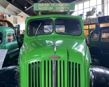 A green vintage truck with sign saying Dover Transport Museum Society