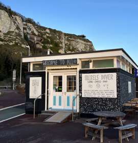 The exterior of Rebels Dover, a cafe and sauna, with the White Cliffs behind.