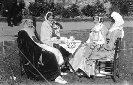 Black and white archive photo from a past Dover Pageant - four people in period costume sitting down to tea