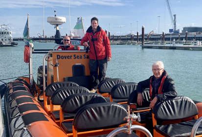 Paul O'Grady sitting in a boat in Dover Harbour