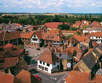 Red tiled rooftops of Sandwich and the black-and-white Guildhall in the centre of the picture
