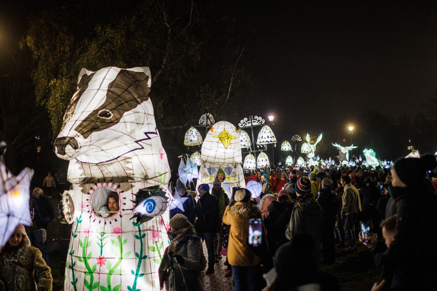 A procession of illumonated lanterns in the shape of animals