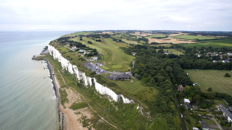 An aerial view of a golf course on top of the White Cliffs of Dover.