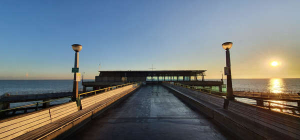 Deal Pier at sunset, looking down the pier towards the sea