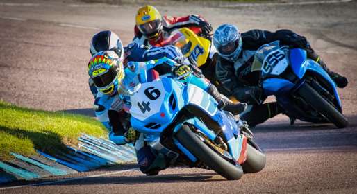 Motorcycles racing around a track.