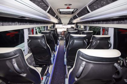 Inside of a minibus looking towards the front.