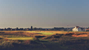 View across a golf course with clubhouse in the distance