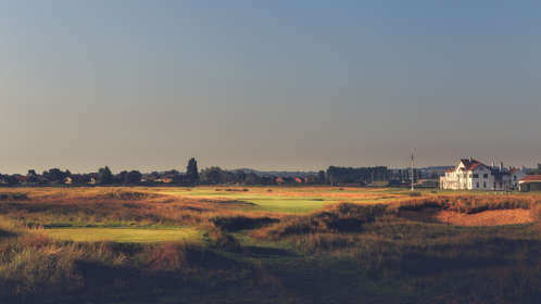 View across a golf course with clubhouse in the distance