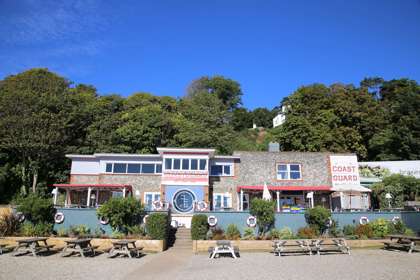 Exterior of the Coastguard with outside seating and benches