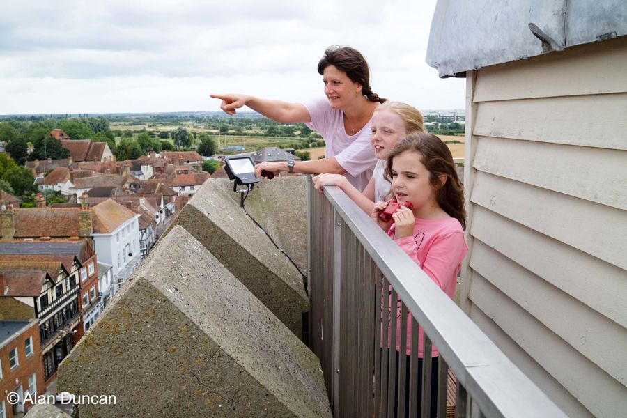 A family looking out at Sandwich from the top of the church tower