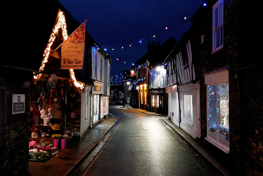 Christmas lights at night on a narrow street