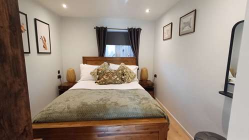 A large bed in a bright bedroom