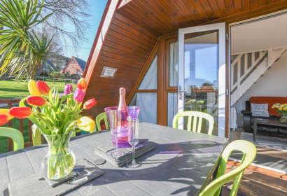 Exterior view with outside seating area, 47 Kingsdown Holiday Park