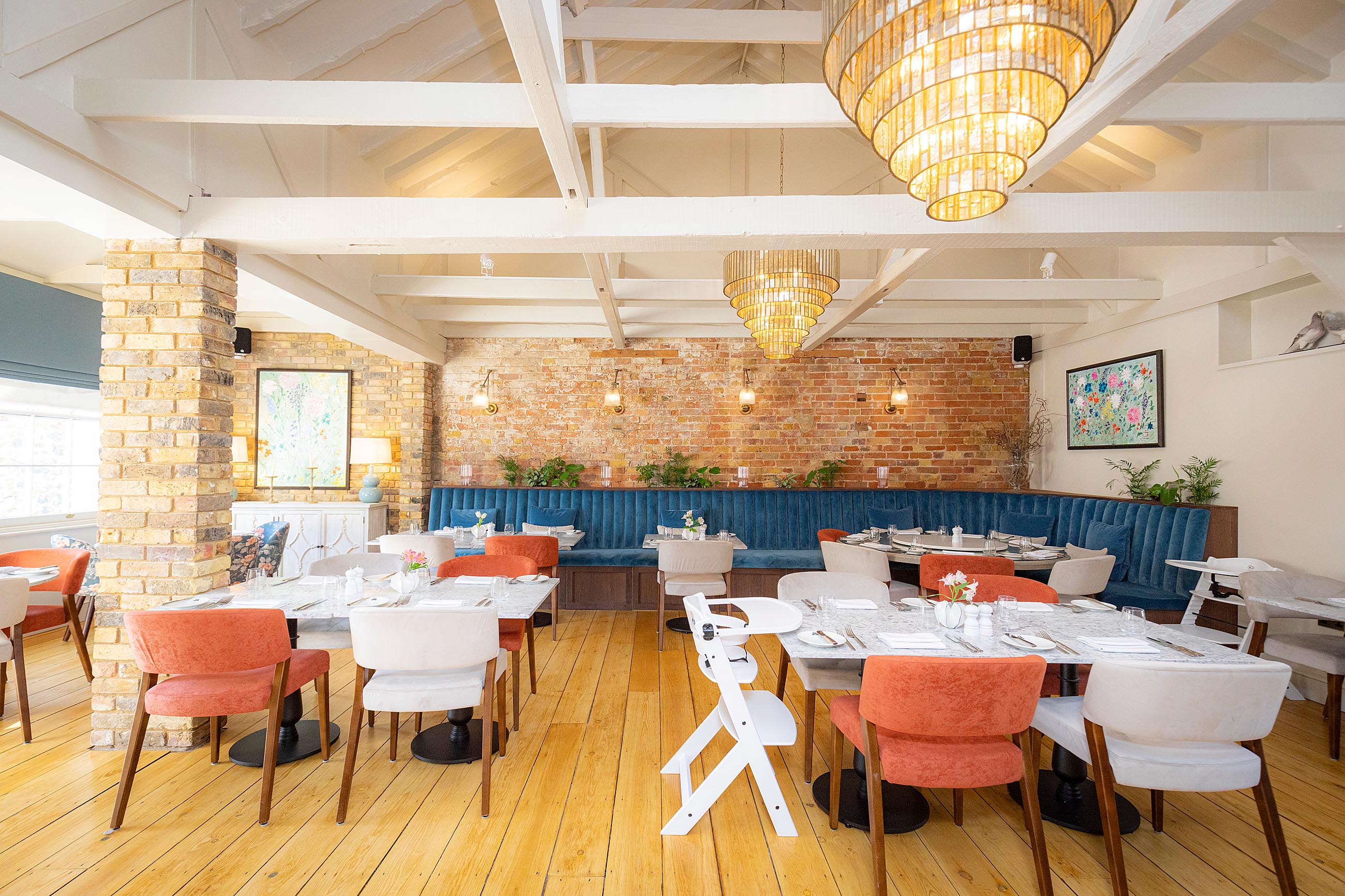 A restaurant with tables laid for lunch service