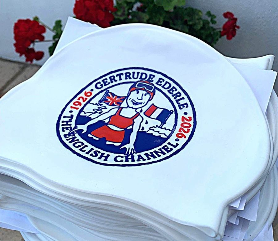 A pile of white swimming caps with a red and blue image on