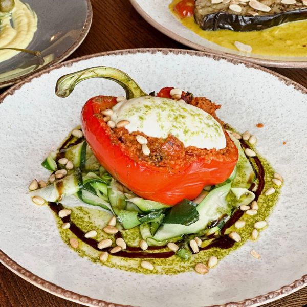 A stuffed red pepper on a bed of courgetti