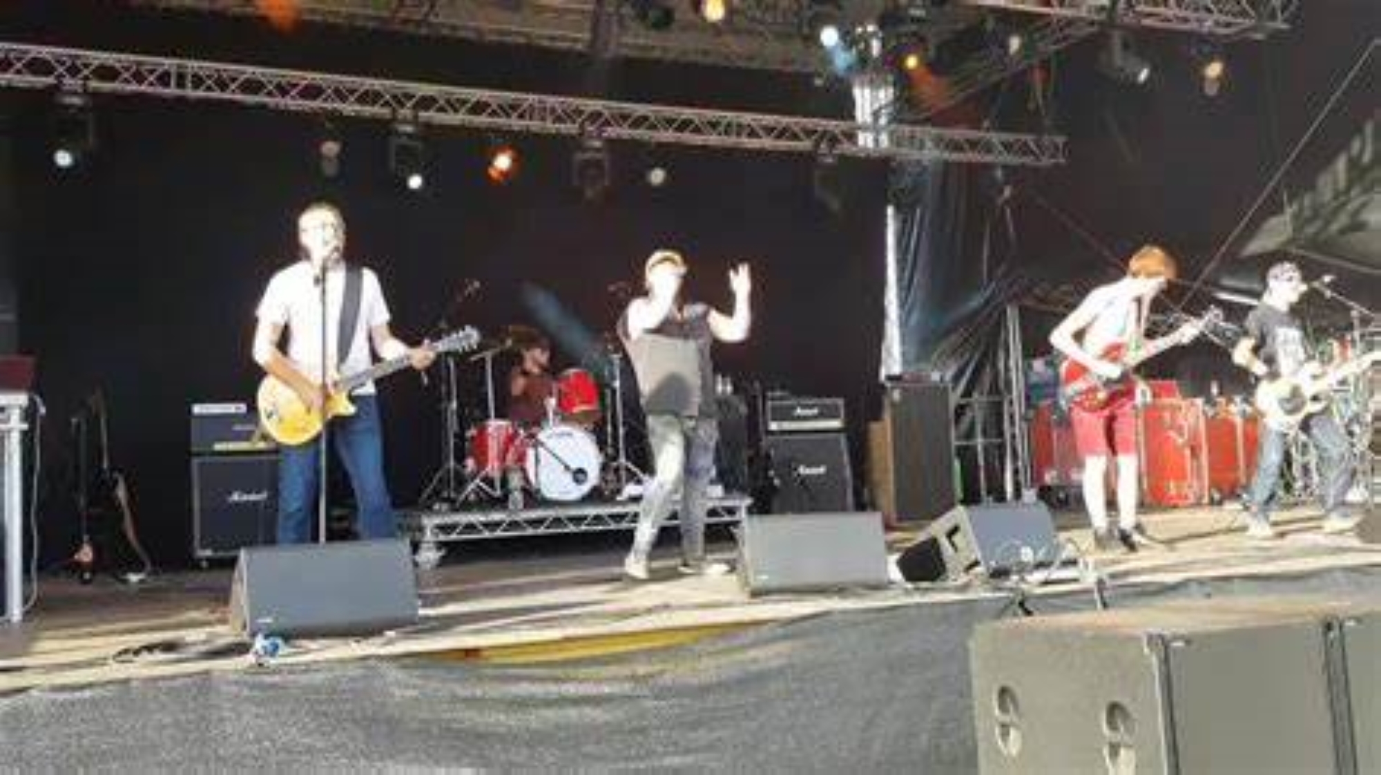Members of the band Let There B/DC performing live on stage