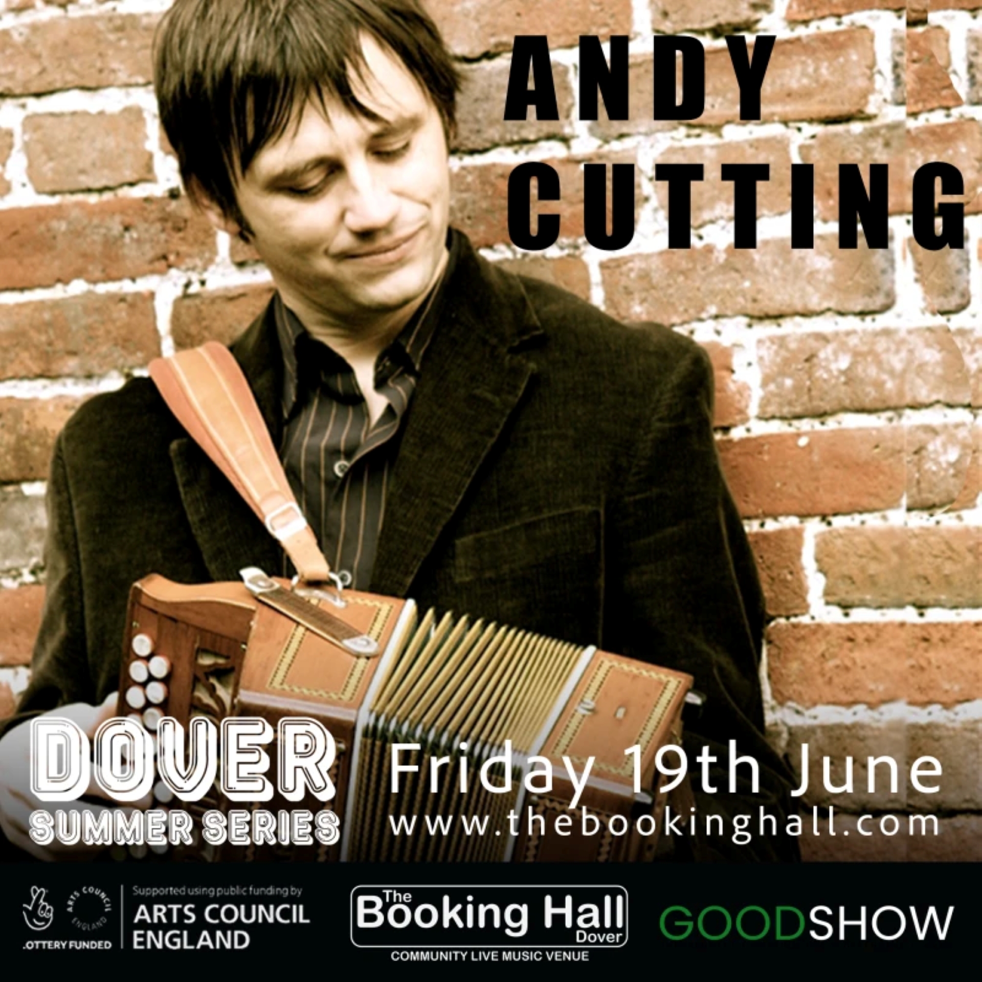 A young man in a dark velvet jacket playing a melodeon.