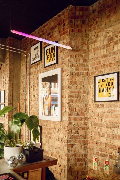 Interior of The Art Club showing brick walls, prints and decor
