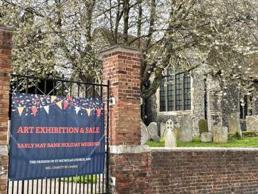 The outer gate of St. Nicholas Church with an event banner