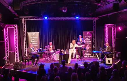 Sue Caroline on stage singing Streisand songs