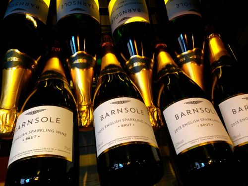 Bottles of Barnsole English sparkling wine lying down with gold tops.