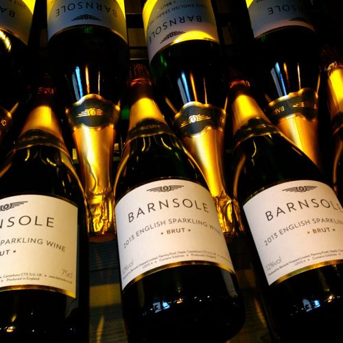 Bottles of Barnsole English sparkling wine lying down with gold tops.