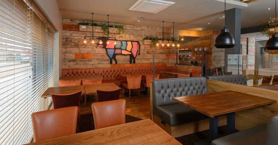 Interior of The Plough showing tables, chairs and benches