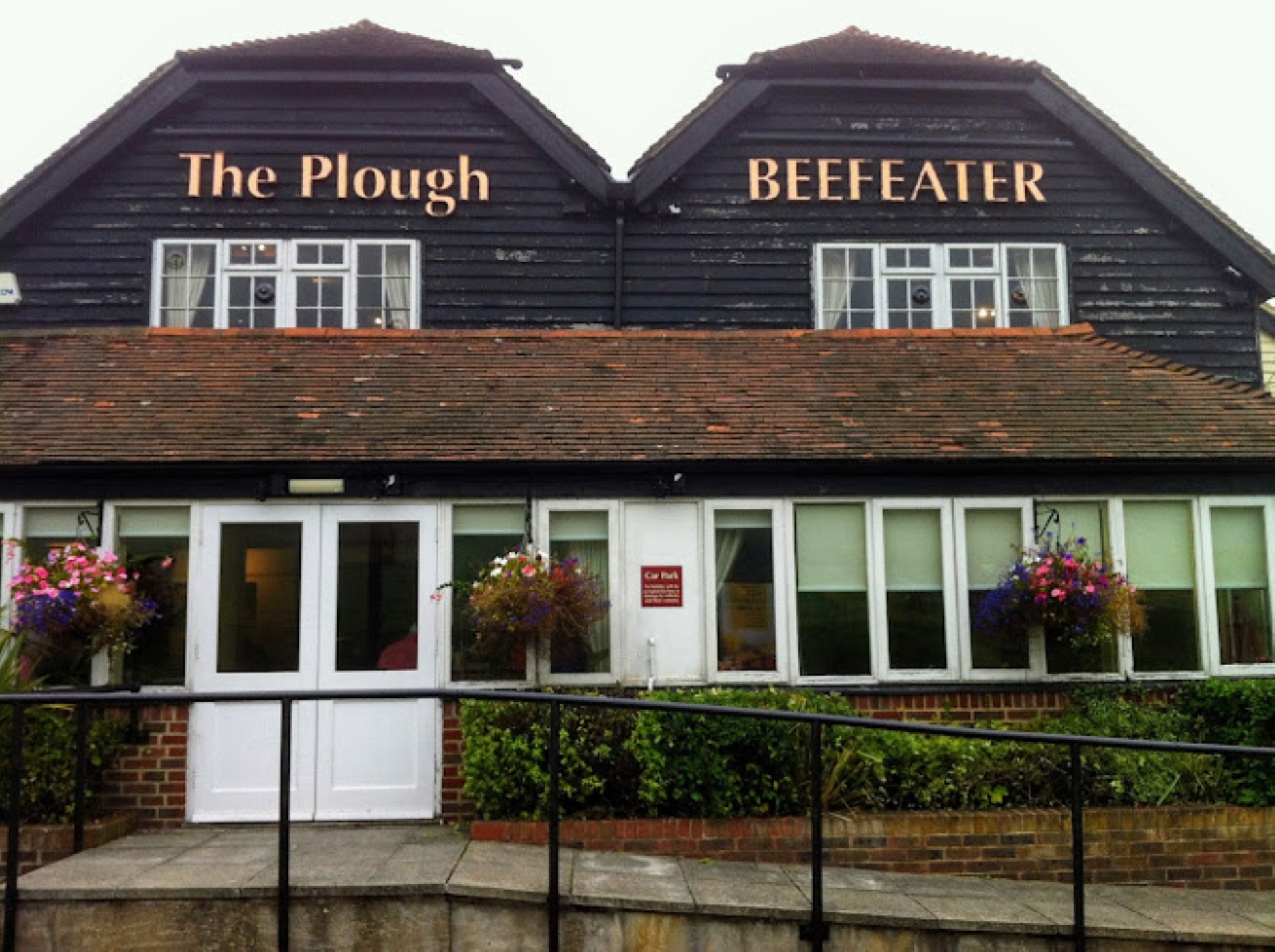 Exterior of The Plough Beefeater with sloped access to double doors