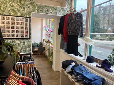 A room with clothing racks and accessories