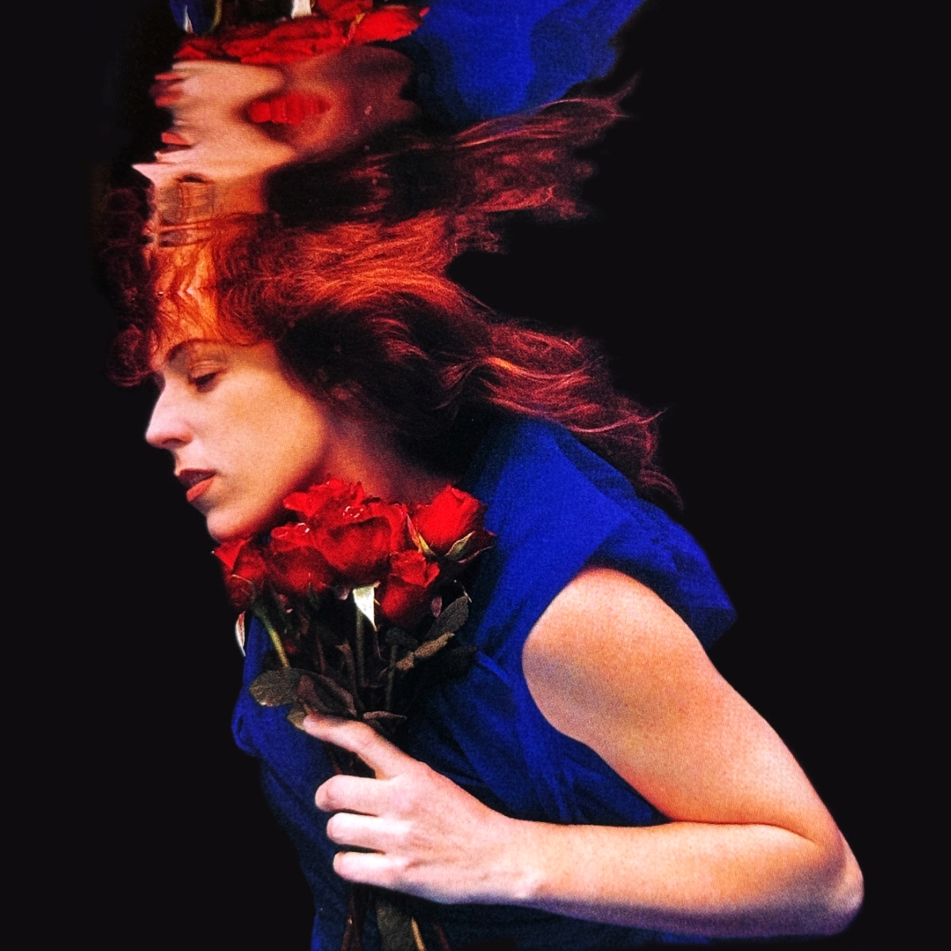 Beth under water holding a bunch of red roses