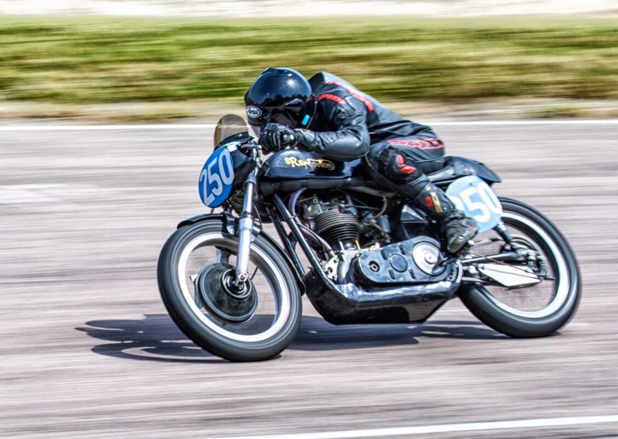 Motorcyclist in leathers racing round a track.