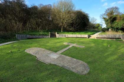 The shape of an aeroplane represented in paving on a grassy bank