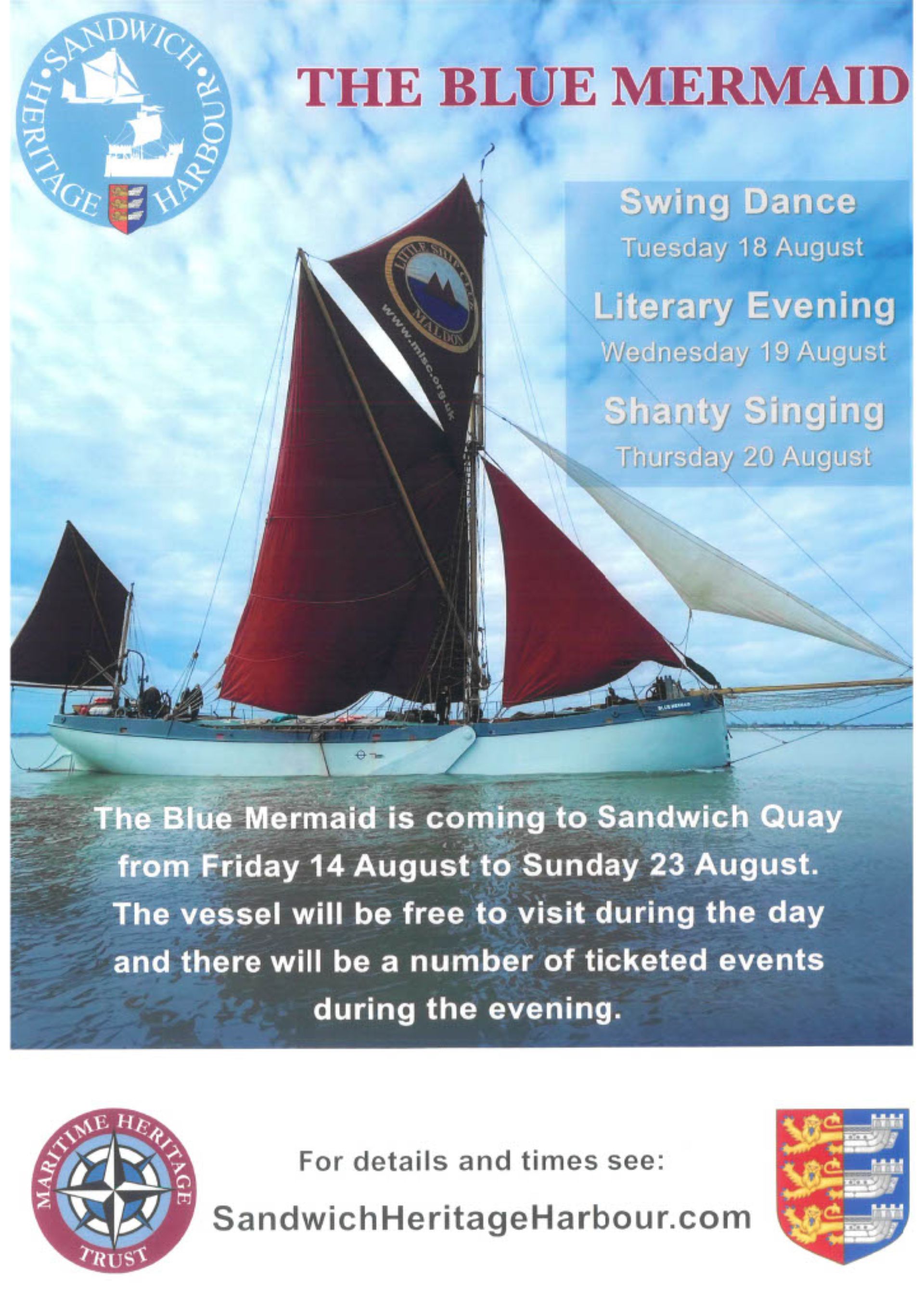 A Thames barge with red sails
