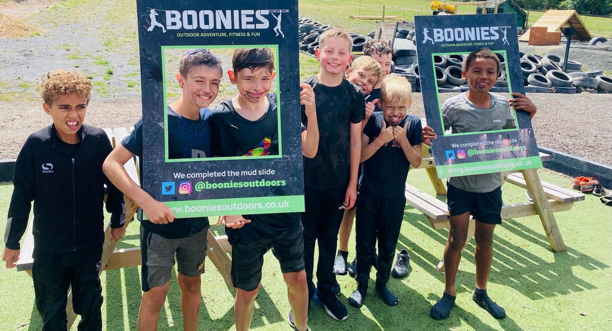 A group of children holiding Boonies posters