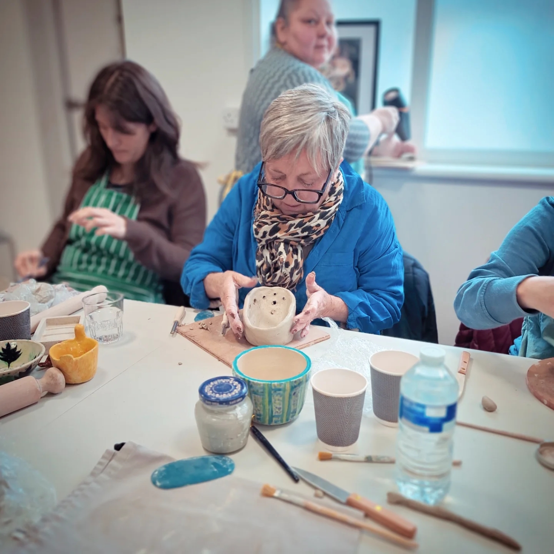 A lady making a ceramic bowl