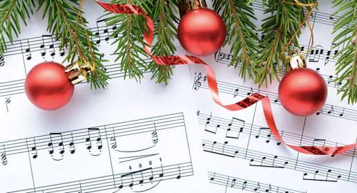 A musical score with pine leaves, Christmas baubles and ribbon