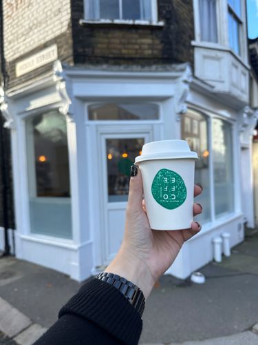 Exterior of Middle Street Coffee Shop featuring an extended are with a coffee cup in the hand