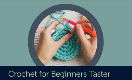 Person crocheting with teal yarn