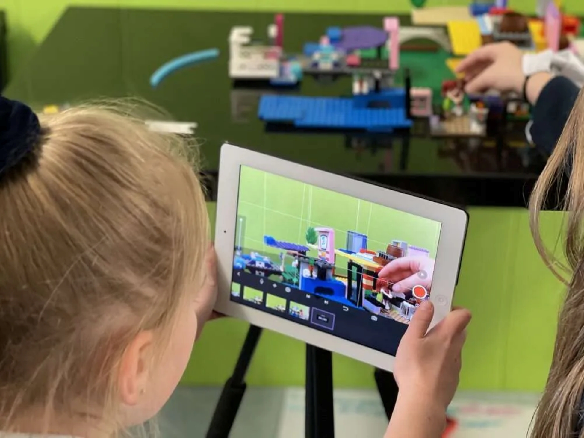 Young girl holding and watching something on an ipad 