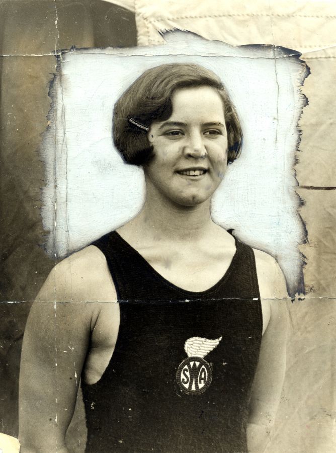 A young woman wearing a black swimming costume