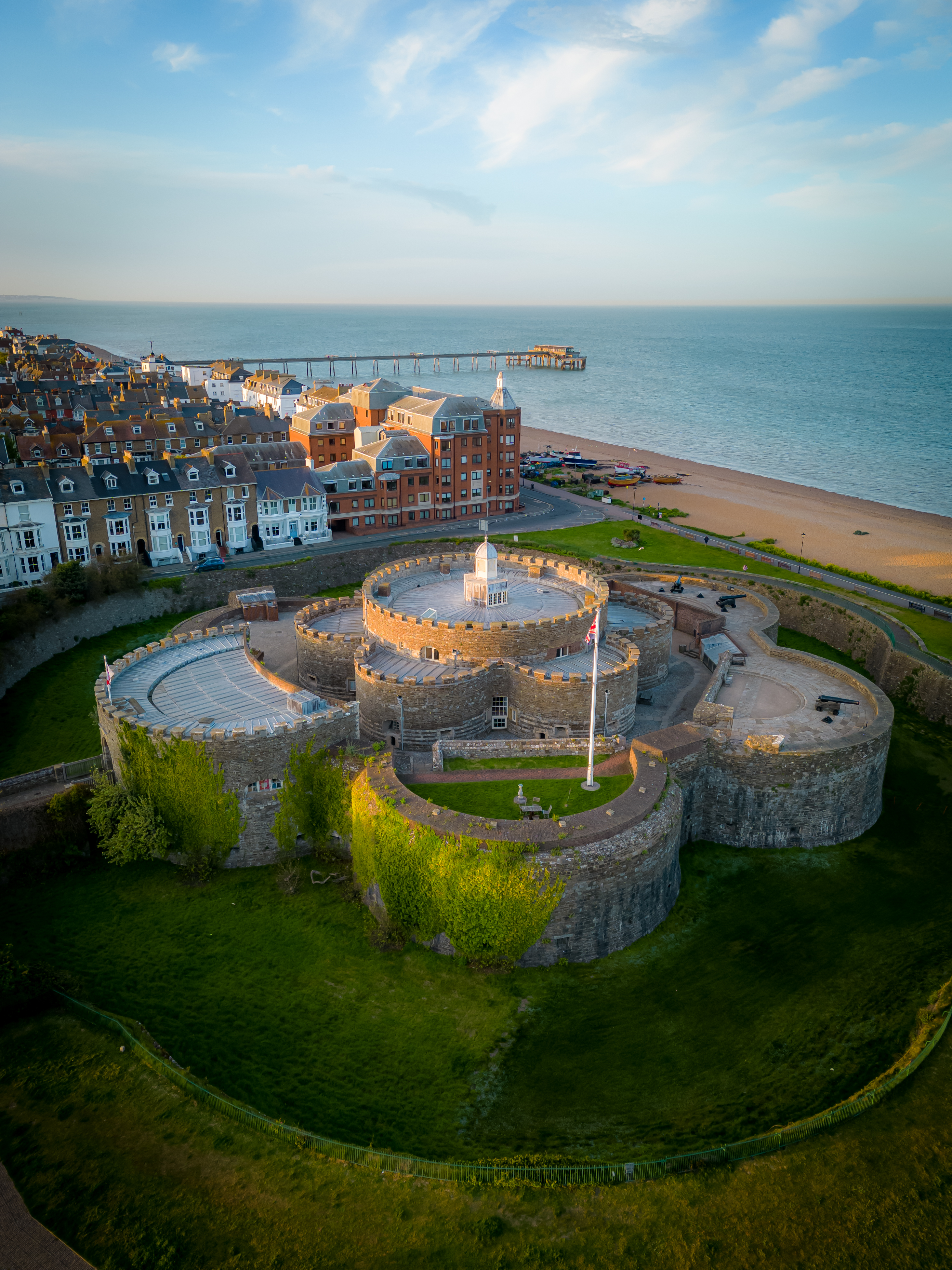 An aerial photo of Deal Castle in the foreground, the beach, buildings and the pier in the background.