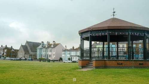 The bandstand on Walmer Green with buildings on The Strand in the background