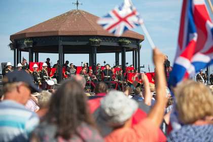 A crowd watching the band on the bandstand