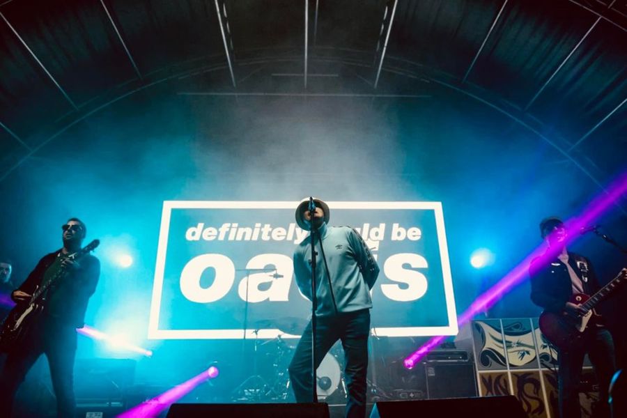 Three band members on a stage 