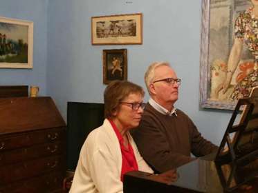 The Douglas Family playing the piano together